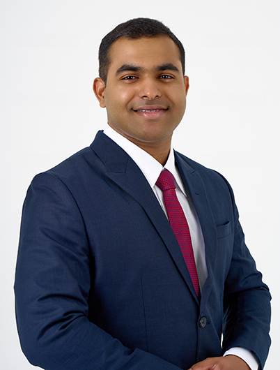 Thejana, smiling, in a casual setting